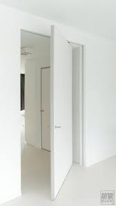 Modern Pivot Door White With An Invisible Door Frame The Hinge Is Completely Integrated Inside The Door And Doors Interior Modern Doors Interior Pivot Doors