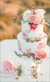 Simple elegant wedding cake with olive leaves and white flowers on a wooden. 11 Simple Wedding Cakes That You Will Love