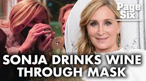 Sonja Morgan manages to drink wine through her face mask