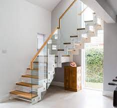 The space under the stairs is actually made functional as well, by setting a work station on that space. China Modern Staircase Design With White Zigzag Metal Beam China Modern Stairs Zigzag Staircase