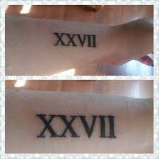 My First But Definitely Not Last Tattoo Xxvii 27 In Roman Numerals I Think I Was Around 9 Or 10 Candy Skull Tattoo Tattoo Roman Numerals Sunshine Tattoo