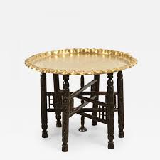 The table's shape and radial bone inlay work gives it a moroccan feel. Vintage Moroccan Etched Brass Round Tray Table