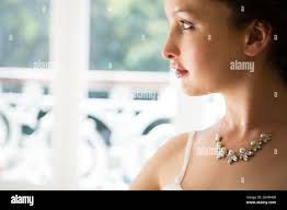 Woman wearing diamond necklace hi-res stock photography and images