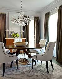 Formal Round Dining Table With Upholstered Chairs And A Crystal Candelabra Chandelier Ashley Goforth Beautiful Dining Rooms Interior Dining Room Inspiration