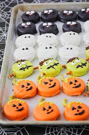 Drop an oreo cookie into the candy melts and use a spoon to cover completely with coating. Halloween Oreos The Baker Upstairs