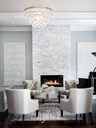 Bling Chandelier Hangs In Front Of Modern Grey Stone Fireplace White Stone Fireplaces Fireplace Design Stacked Stone Fireplaces