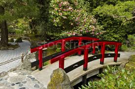 A photograph taken of the beautiful garden from the top of an arched japanese wood bridge in a oriental style landscaped garden. Japanese Garden With Red Bridge Stock Photo C Tab62 2693984 Stockfresh