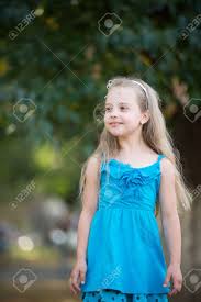 Girl blonde woman model portrait fashion female smile hair young woman. Small Baby Girl Or Cute Child With Adorable Smiling Face And Bow In Blonde Hair In Blue Dress Outdoor On Blurred Background Stock Photo Picture And Royalty Free Image Image 74515182