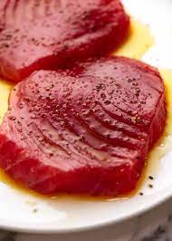 For this tuna marinade, mix 1 cup of low sodium soy sauce, ½ cup of lemon juice, 2 cloves of garlic and salt and pepper to taste. Tuna Steak Recipetin Eats
