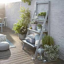 This kitchen has a southwest flair with orange tones mimicking the desert and stainless steel offering a striking contrast. Small Garden Ideas Ideas Advice Diy At B Q Small Gardens Garden Sitting Areas Small Courtyard Gardens