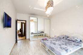 Modern and contemporary bedroom sets look best when they are in a space that is free of clutter. Big Modern Bedroom In White Tone Bed And A Wardrobe With A Large Stock Photo Picture And Royalty Free Image Image 36984920