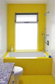 However, the cool yellow tones present in the bathroom below help in creating a happy mood without the interference of the black accents that we can see splashed on the tiled wall and the shiny tiled flooring. Obsessed With Yellow 19 Eye Catching Ideas Yellow Bathrooms Yellow Bathroom Decor Yellow Bathroom Tiles