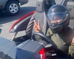 Image of someone driving a Slingshot with and without a helmet