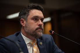 Gray defends voter registration rule proposal in tense public hearing