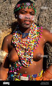 Zulu woman in beads and native costume topless near Kruger National Park in  South Africa near hut Stock Photo - Alamy