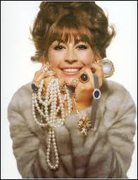 Jessica Ford in salmon-colored wool tweed suit by Handmacher, and natural  Milan straw hat by Emme. Photo by Leombruno-Bodi, 1959