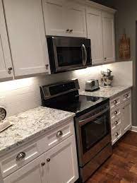 With the love for modern farmhouse kitchens, white shaker cabinets were an easy decision for this kitchen remodel. Farmhouse Kitchen With Shaker Style Cabinets Painted In Sherwin Williams Snowbound White Subway Tile Farmhouse Kitchen Cabinets Kitchen Design Kitchen Remodel