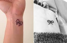 Small bow tattoo design looking very cute. Cute Small Bow Tie Tattoo