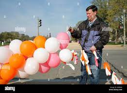 Men popping balloons