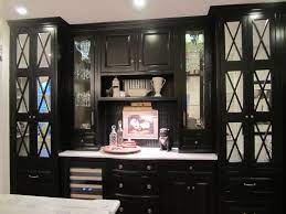 Cabinets with glass displays are great for showcasing beautiful vases, knick knacks and even fine china, all while keeping them safely stored. Dining Room Built In Replace With Oak And Cast Iron Details Black Counter Dining Room Built Ins Dining Room Built In Custom Dining Room
