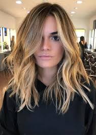 The wavy tendrils can be tucked behind one ear or easily swept up and pinned in a pompadour style. 29 Medium Length Hairstyles For Women To Try