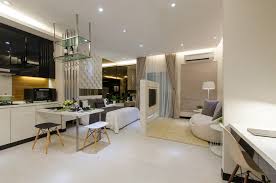 The kitchen units are kept light to prevent the room from feeling too cramped. Apartment Design Malaysia