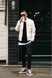 Black And White Bomber Jacket Mens Layered Look With Black Pants A White Bomber Jacket A Black Sweater And Grey Chucks Mens Outfits Mens Street Style Menswear