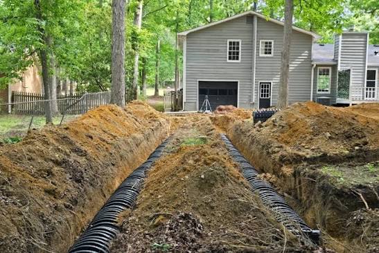 Heavy equipment performing site excavation for septic system