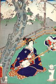 これは国貞の源氏絵 春の遊楽 文久１ １８６１９年 です 桜の庭というサブタイトルがついています 優雅な花見ですね 三味線を弾いている芸者がことさら豪華な衣装を着ているのには理由がある 王朝文学の 源氏物語 を江戸時代の大奥に置き換えた 柳亭