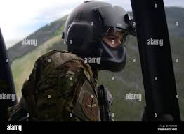 Tech. Sgt. Travis Kidwell, 40th Helicopter Squadron UH-1N Iriquois flight  engineer, calls approach to the pilots as they descend into the landing  zone July 6, 2016, near Malmstrom Air Force Base, Mont.