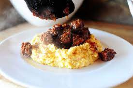 Spicy Stewed Beef With Creamy Cheddar Grits Recipe Beef Recipes Recipes Spicy Stew