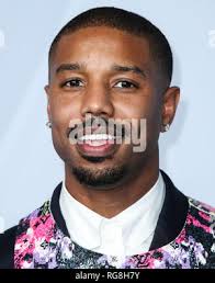 Michael B. Jordan poses in the press room with his awards for outstanding  actor in a motion picture for “Creed” and entertainer of the year at the  47th NAACP Image Awards at