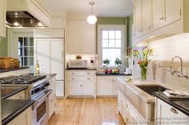 Glossy white kitchen cabinets with medium wood finished breakfast counter. Rwkcwf50 Remarkable White Kitchen Cabinets Wood Floors Wtsenates