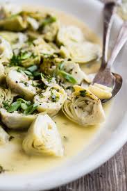 Artichoke Hearts Make The Best Appetizer For Summer Parties These Are Cooked In A Light White Wine And Garlic Artichoke Recipes Best Appetizers Veggie Dishes