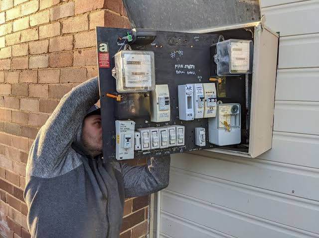 Electrician tightening connections on a consumer unit in Chislehurst