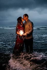 How Dreamy Is This Couple Standing In The Ocean With Sparklers So Stunning Couple Beach Pictures Couples Beach Photography Beach Photoshoot