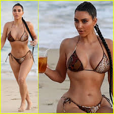 Kim kardashian hit the beach saturday in some skintight snakeskin swimwear, as she enjoyed a girls trip with her sisters and daughters to turks and caicos, taking a boat out onto the. Kim Kardashian Flaunts Her Curves In A Bikini See The Beach Photos Bikini Kim Kardashian Just Jared