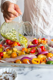 Adding Marinade To The Herby Feta Lemon Chicken And Veggie Sheet Pan Dinner Recipe By Baking Sheet Pan Dinners Recipes Sheet Pan Dinners Family Dinner Recipes