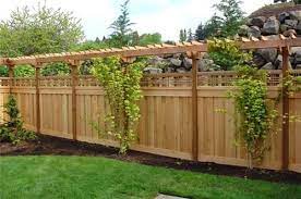 Wooden privacy fences are one of the most popular choices for backyards because they're relatively inexpensive and come in many different styles. Love The Lattice Over Top Of Privacy Fence Backyard Fences Backyard Privacy Fence Designs