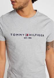 Tommy hilfiger b.v., formerly known as tommy hilfiger corporation and tommy hilfiger inc., is an american premium clothing brand, manufactur. Tommy Hilfiger Logo Tee T Shirt Print Grey Hellgrau Meliert Zalando De