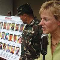 Masom Jan, an Afghan farmer, shows U.S. Army Sgt. Bethany