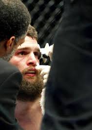Ben Wall (top) fights Justin Salas (red gloves) during a preliminary  lightweight bout at US Bank Arena. 65107464 Editorial Image