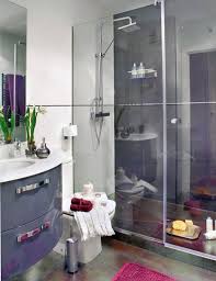 A contrasting small bathroom with a black statement wall and vanity, a shower, a round mirror and a bowl. How To Make A Small Bathroom Look Bigger Tips And Ideas
