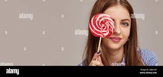 Girl hiding candy hi-res stock photography and images
