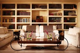 Stacked books, steaming cup of coffee and glasses on a round wooden table in a colorful vector cartoon illustration in concepts of reading, studing or personal entertainment. Rome Stacked Book Coffee Table Living Room Contemporary With Light Colors Dimmer Switch Italian Style