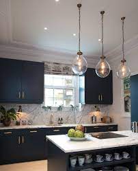 Marble Kitchen Dark Blue Cabinets Brass Hardware Glass And Brass Light Pendants Kitchen Design Brass Wa Kensington Apartment Kitchen Design Kitchen Marble