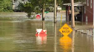 Flooding on a street in Indianapolis with emergency vehicles present.