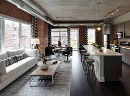 Modern Loft Living Room And Open Kitchen With Dark Hardwood Floors Exposed Brick Exposed Ductwork Indust Loft Apartment Designs Luxury Loft Apartment Design