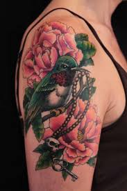 Floral tattoos have become common elements in the tattooing work as most of the tattoos are incorporated with flowers. Colored Bird And Flowers Tattoo On Half Sleeve