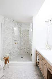 Metallic copper shower floor looks absolutely gorgeous and refined. Angled Walk In Shower With White Penny Tile Floor Transitional Bathroom
